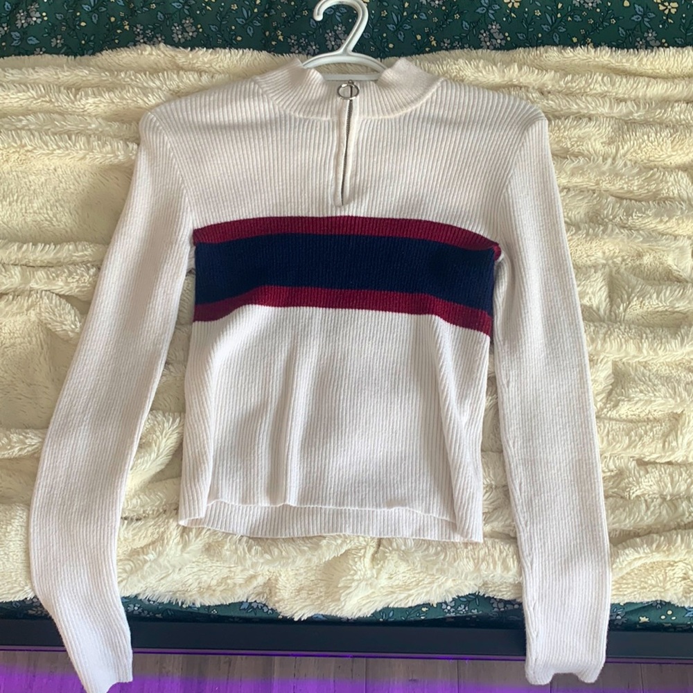 Cute white, maroon, and blue sweater. Stretchy material and in good quality.